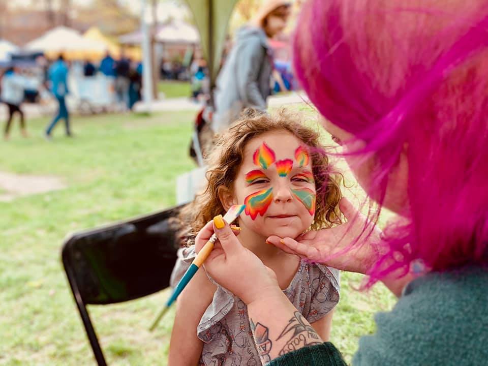Child with beautiful butterfly face painting design