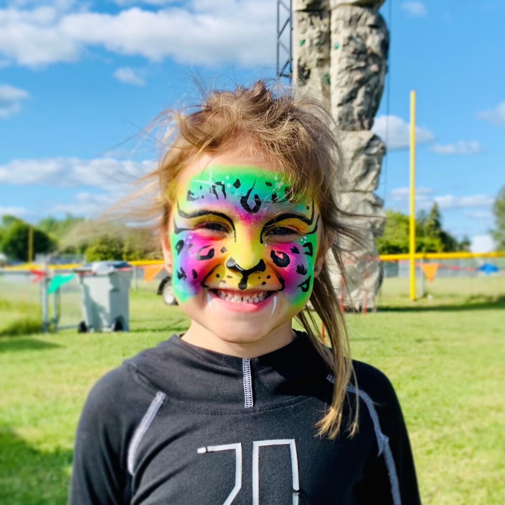 Child with leopard face painting design showing spotted pattern